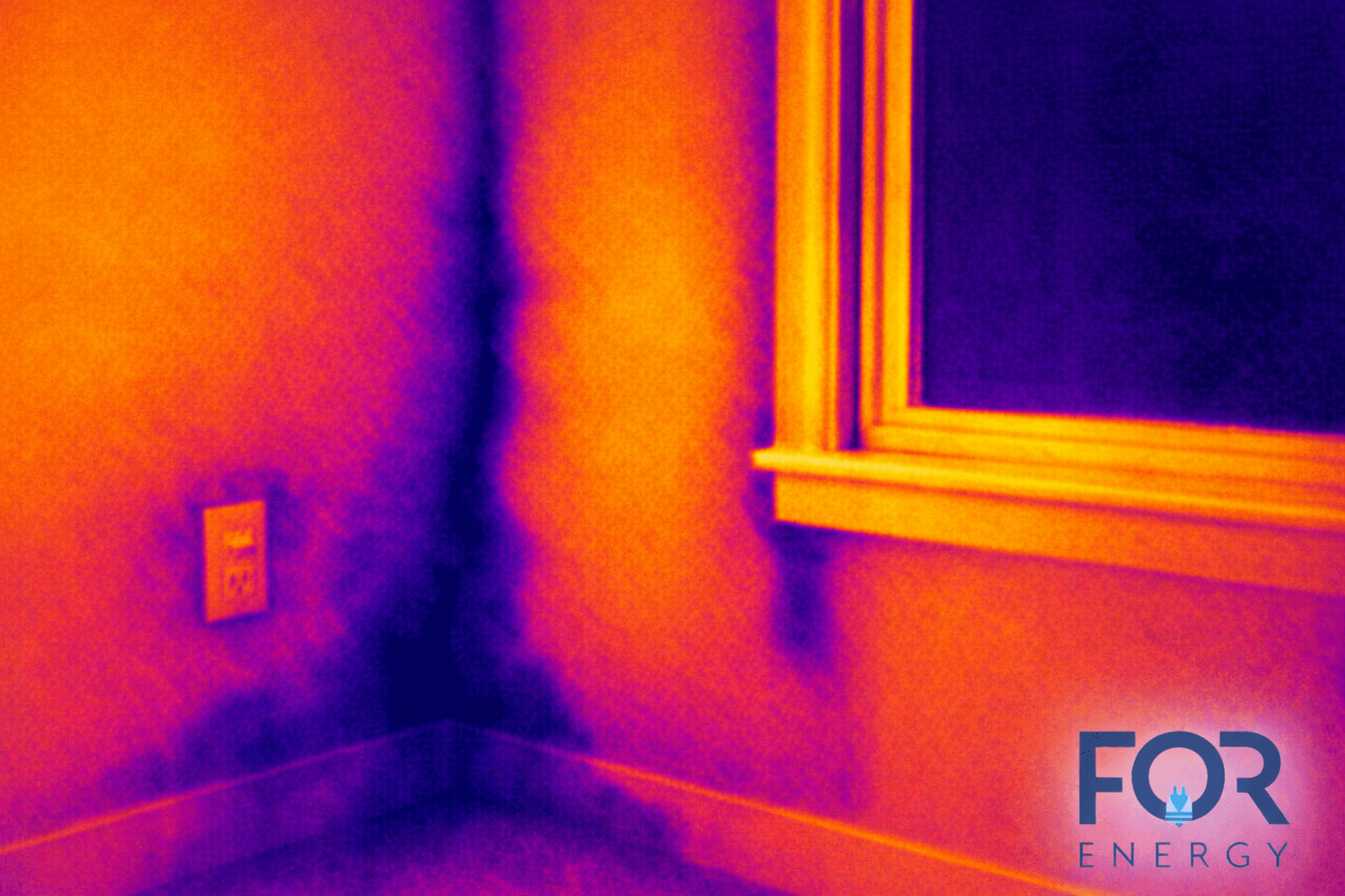 Thermal image of an interior wall corner and window. Bright yellow and orange areas around the window frame and trim indicate warmer temperatures, while darker purple and blue areas along the wall and corner suggest cooler spots or possible air leakage. An electrical outlet is visible on the wall. The FOR Energy logo appears in the bottom right corner.